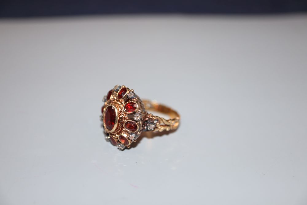 A 19th century 18ct, garnet and rose cut diamond set oval cluster ring, size O, gross 7 grams,